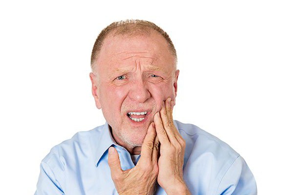 почему болят десны и зубы