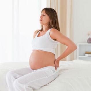 почему болит спина при беременности